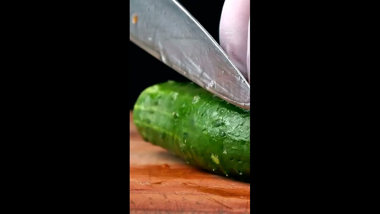 Title: "Unexpected Kitchen Visitor: Cat's Hilarious Encounter with a Cucumber
