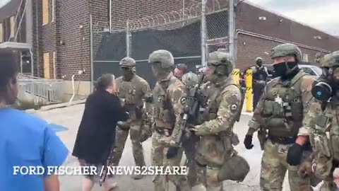 Elderly Protester Confronts ICE Officers at Detention Facility Gate