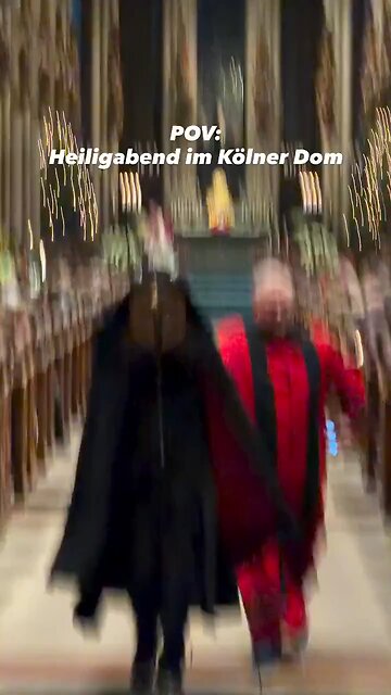 A video of a man in a black cloak and a gold mask interrupting a Christmas service at