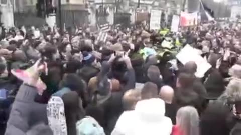 Police chased out of the crowd by protesters chanting “we stand together”