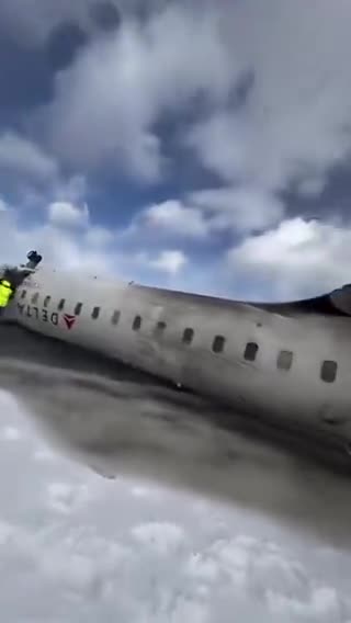 Traveler aboard a Delta flight that crashed in Toronto records escaping onto a snowy runway.