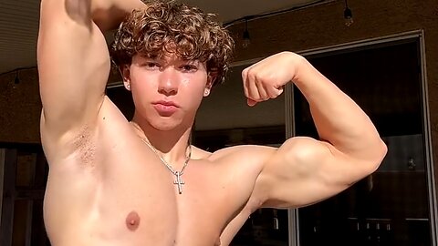 Handsome muscular man showing off his muscles