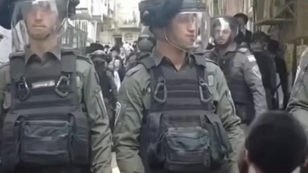 Ultra-Orthodox Jews protest in Jerusalem and hold up the Palestinian flag