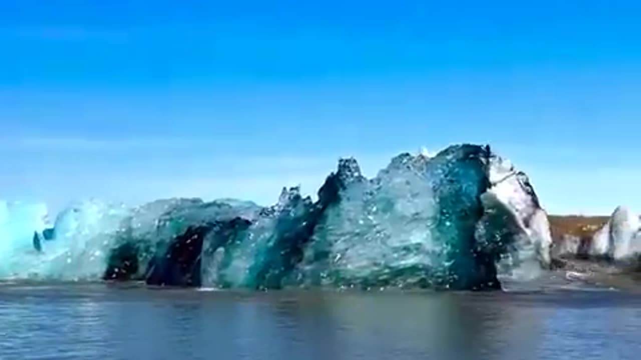 A magnificent iceberg flipping