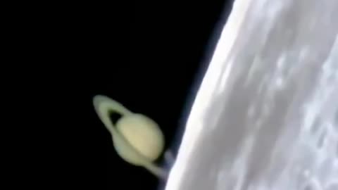authentic footage showing Saturn emerging from behind the Moon