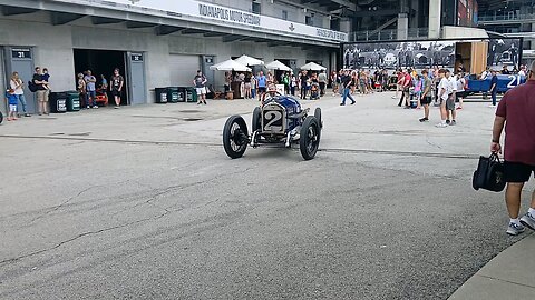 classic race cars heading to track at the Indianapolis Motor Speedway