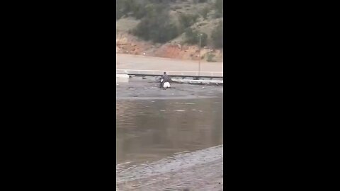 Locals capture insane footage of man riding a horse in dangerous flood waters to