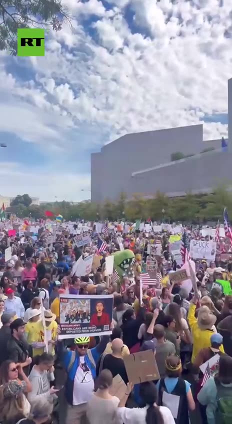 Protestor waves flag of Ukraine, ruled by a brutal dictator