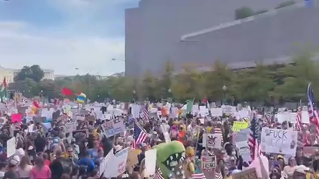 Protestor waves flag of Ukraine, ruled by a brutal dictator
