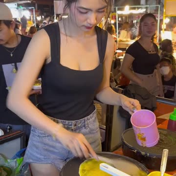 Beautiful lady cooking omelette rice at Vientiane Laos