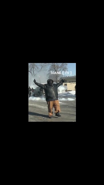 Big Black Protestor in Minneapolis laughs as he swaggers down the street, giving the finger