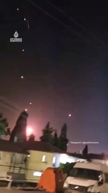 A barrage of Iranian missiles making impact in Tel Aviv