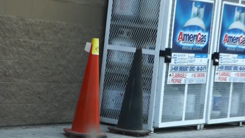 A black traffic cone with it's friend