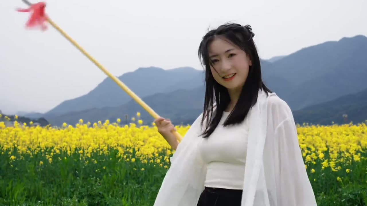 Flowers bloom across the fields, and with a red tassel spear in hand