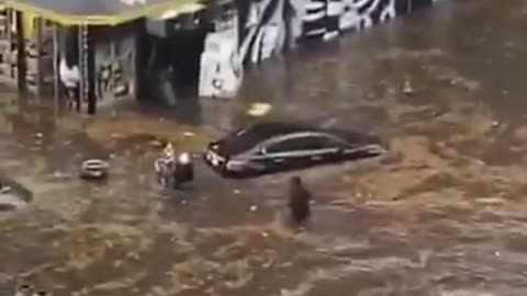 Two people died when heavy rainfall led to flash flooding, inundating streets and