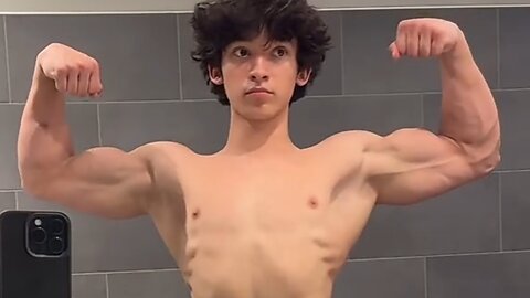 15 years old teen bodybuilder flexing big biceps