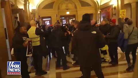 Protesters outside MN Gov. Tim Walz's office in the State Capitol chanting 'Do your job!