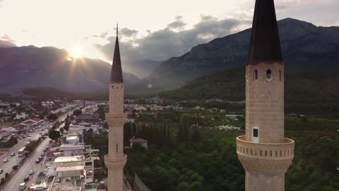 Scenic View of Kemer City and Mosque with Majestic Mountain Backdrop