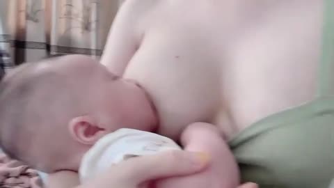 Breastfeeding: Feeding a Baby with Pretty Mother