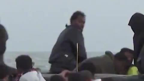 Dozens of migrant men clamber aboard dinghy to get to Britain