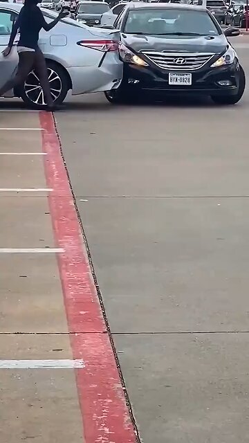 A woman accidentally hit a parked car while backing out. #Accident #Traffic #japd