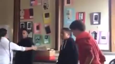 Diverse student knocks out another diverse student for hitting the teacher