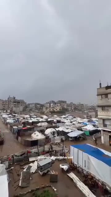Young men are opening up a rainwater drainage drainage near tents