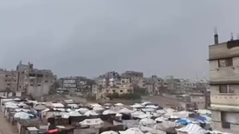 Young men are opening up a rainwater drainage drainage near tents