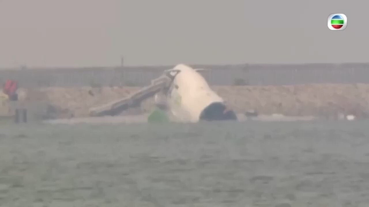 Cargo plan skids off Hong Kong runway into sea during landing, killing 2 airport workers