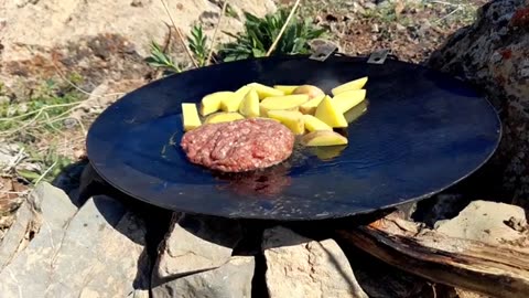 Cooking cheeseburger in beautiful nature