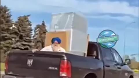 Only in Brampton: old man in turbine rides with appliances in back of truck