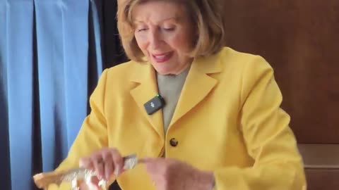 Nancy Pelosi breaks a fake crown to protest Trump.