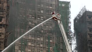 Hong Kong firefighters battle apartment blaze amid great danger