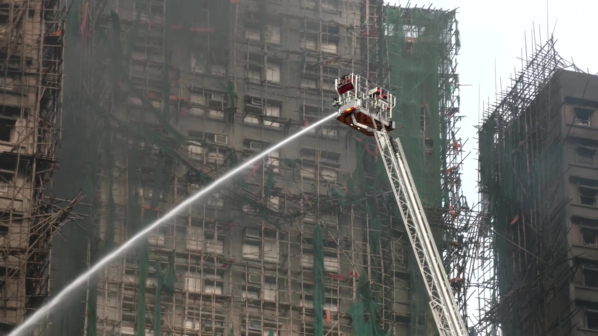 Hong Kong firefighters battle apartment blaze amid great danger
