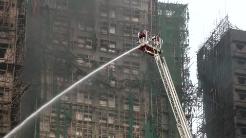 Hong Kong firefighters battle apartment blaze amid great danger