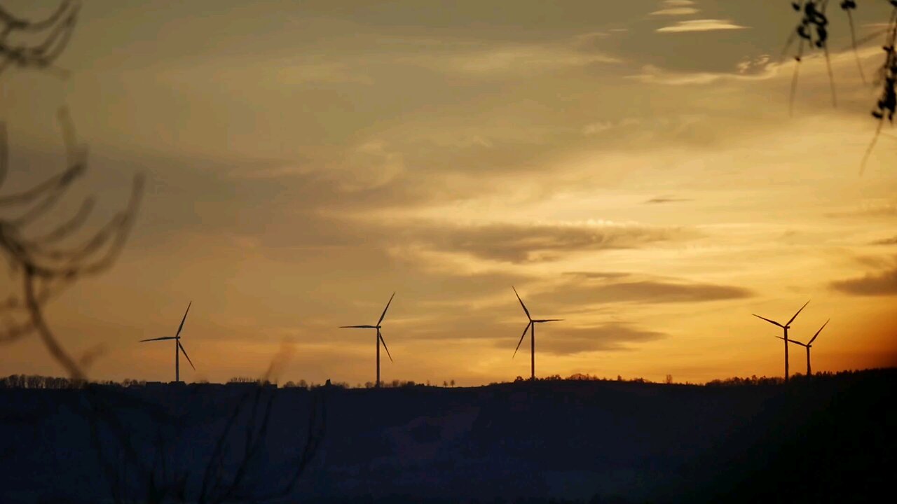 View Of Wind Turbines At Sunset