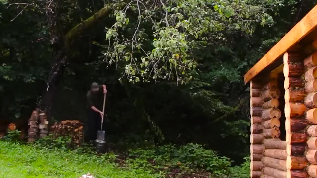 A man builds a house in the forest with his own hands