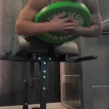 Ilia Topuria putting in the work for more strength and stability with weighted back extensions