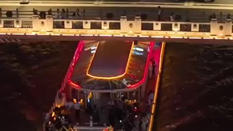 As night falls, the Haihe River in Tianjin, China, transforms into a mesmerizing, flowing canvas