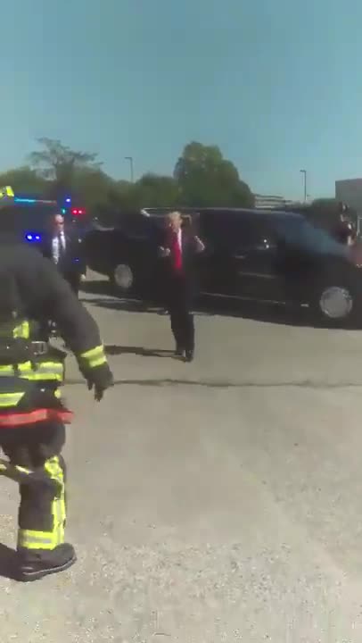 His motorcade saw a group of Firemen saluting him, so he stopped the car and got out to thank them