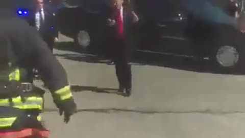 His motorcade saw a group of Firemen saluting him, so he stopped the car and got out to thank them