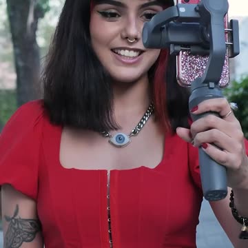 Blogging girl down the street with his cell