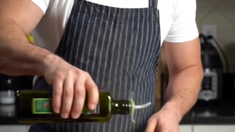 A man grills seasoned chicken breasts