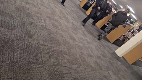 Police escorting someone out at the local community center(LIBRARY!!)