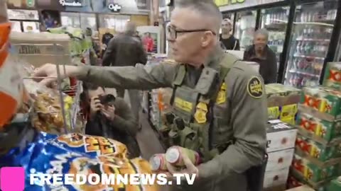 Commander Bovino, along with Border Patrol agents, picks up carb-free snacks (Cracklins)