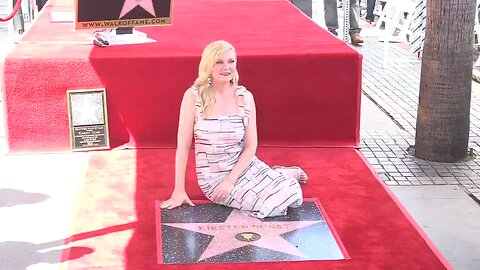 Kirsten Dunst poses with her star on the Hollywood Walk of Fame