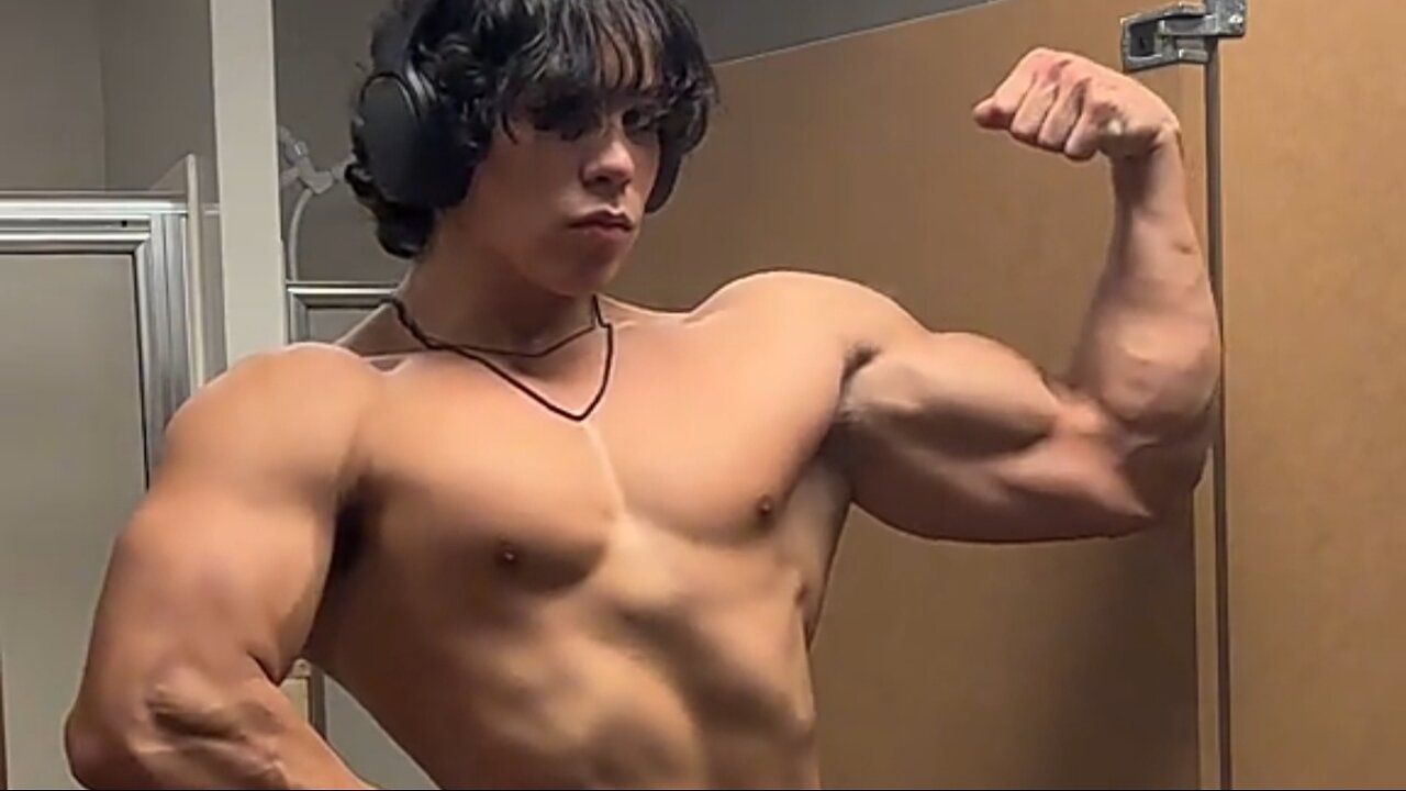 18 years old bodybuilder flexing muscles