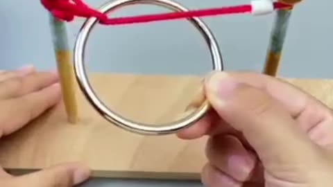 A puzzle game of how to get out the ring of the ropewithout removing the sticks