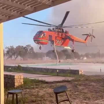 Helicopter extinguising forest fires on Rhodes Island
