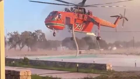 Helicopter extinguising forest fires on Rhodes Island